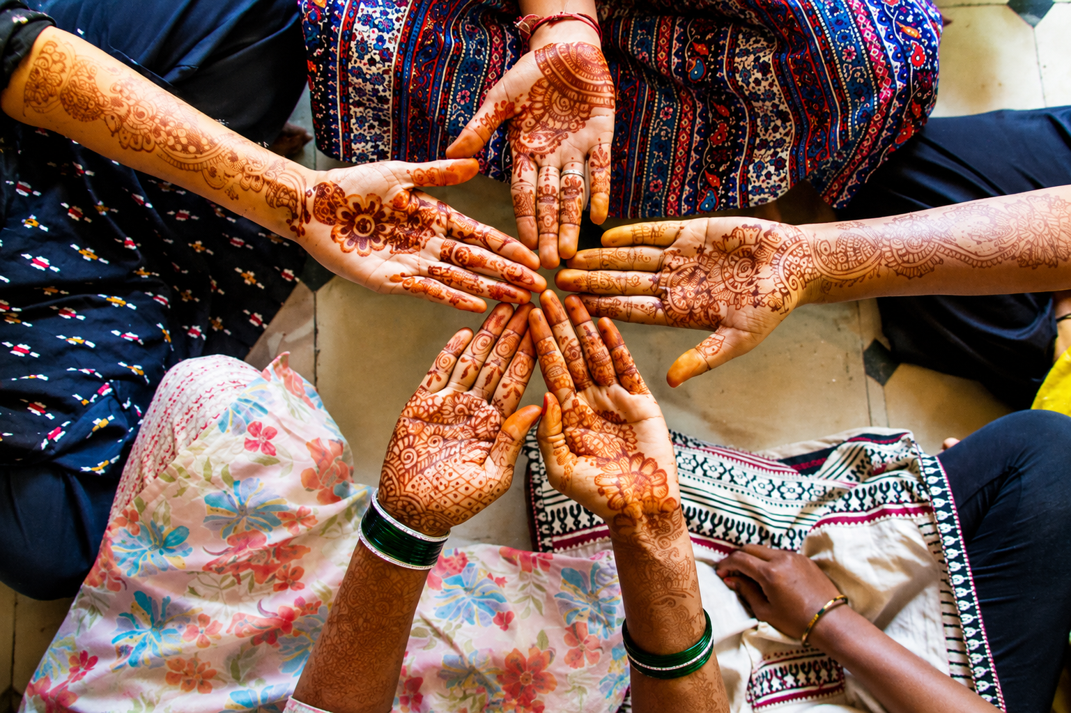 Women showing henna designs together